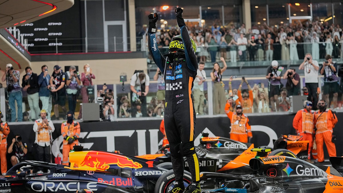 Lando Norris gets out of his vehicle