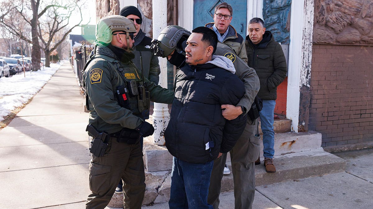 Federal immigration enforcement agents detain an individual