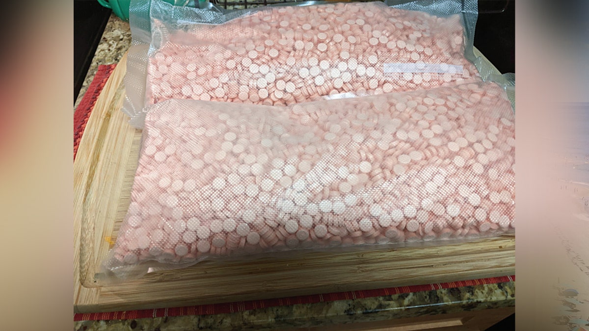 bags of thousands of pink pills