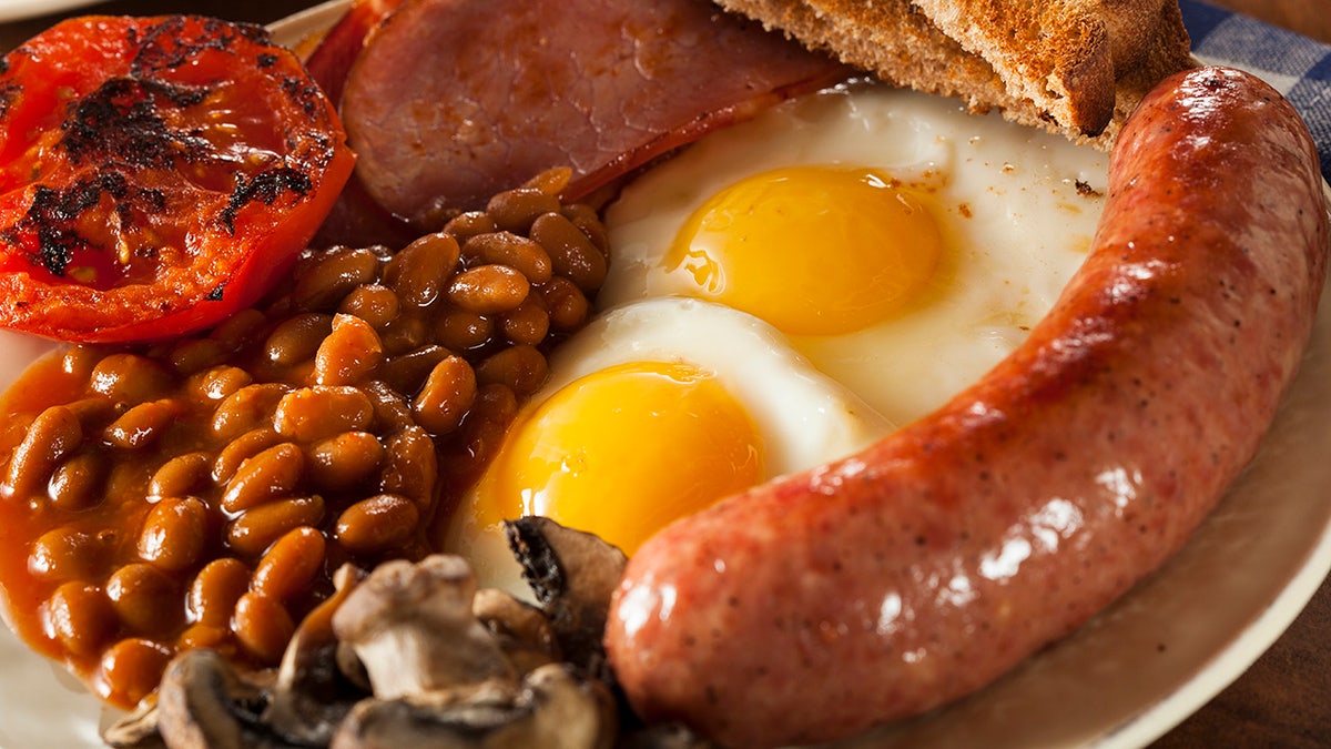 Traditional Full English Breakfast with Eggs, Bacon, Sausage, and Baked Beans