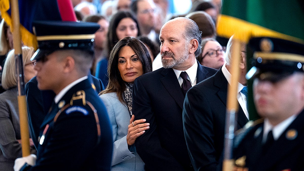 Commerce Secretary Howard Lutnick stands with his wife Allison as they attend a Holocaust remembrance event in Emancipation Hall.
