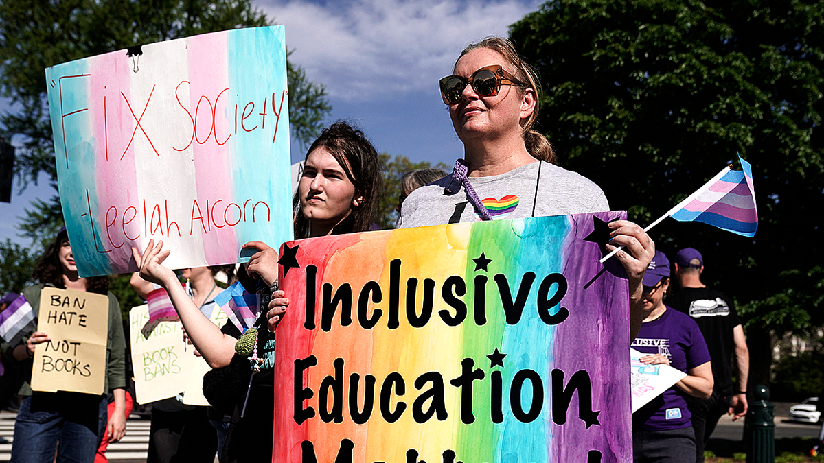 Pro-LGBTQ books protesters hold 'inclusive education matters' sign