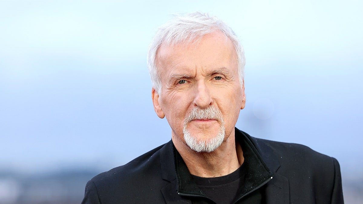 James Cameron stands and poses for photos during an 'Avatar: Fire and Ash' photocall in Paris.
