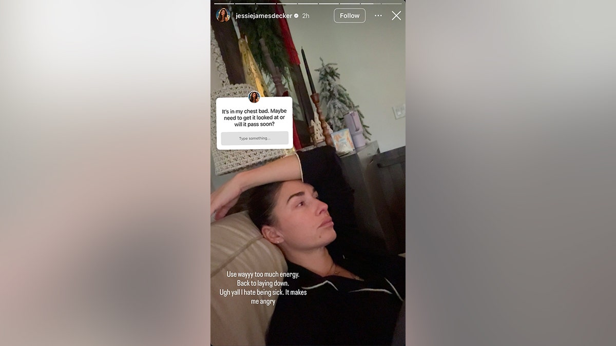 Jessie James Decker laying down on the couch