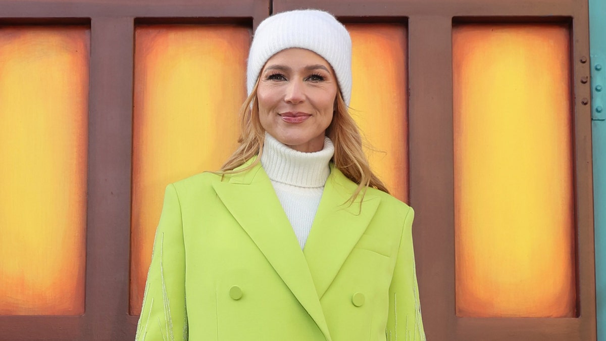 Jewel in a green coat and white beanie at the 2025 Macy's Thanksgiving Day Parade in New York in November.