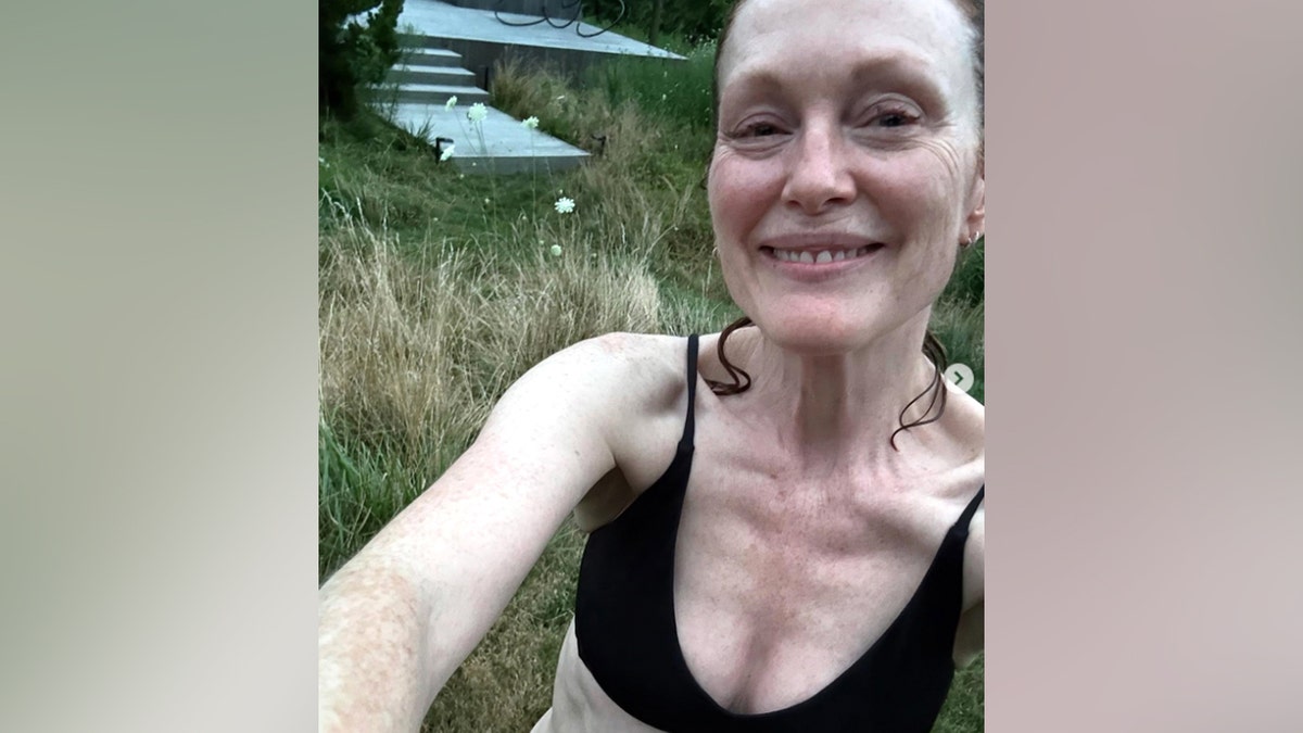 Julianne Moore shares a makeup-free selfie wearing a black bikini top while spending time outdoors in a photo posted to Instagram on Aug. 12, 2025.