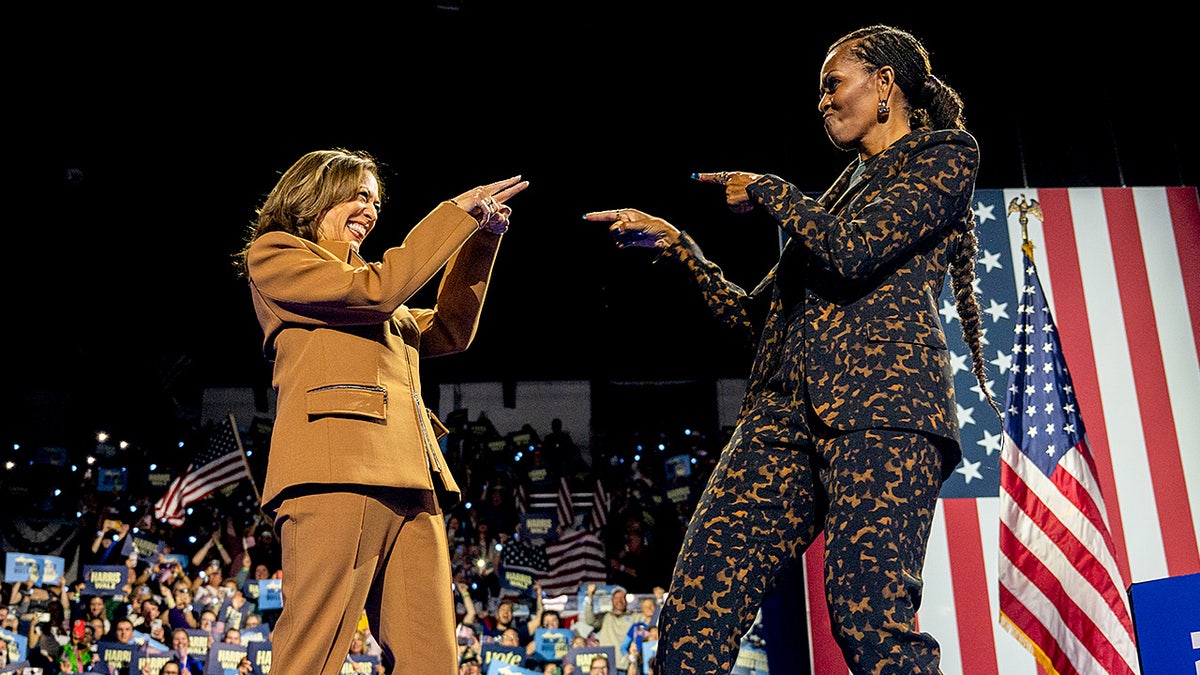 Kamala Harris and former First Lady Michelle Obama greet each other warmly on stage during a campaign rally in Kalamazoo, Michigan.