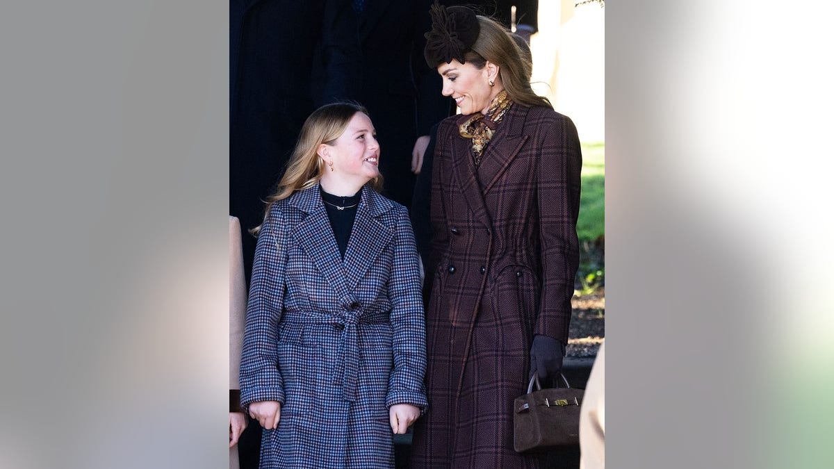 Kate Middleton smiling at a beaming royal child.