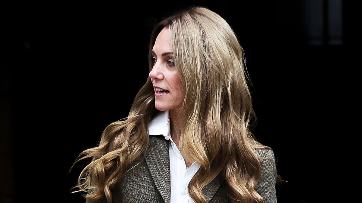 A close-up of Kate Middleton looking away from the camera showing off her lighter hair.