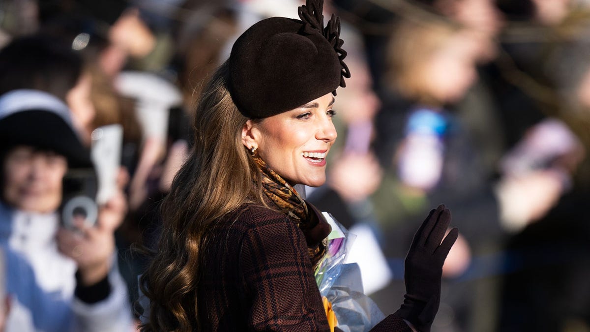 Kate Middleton waving to the public.
