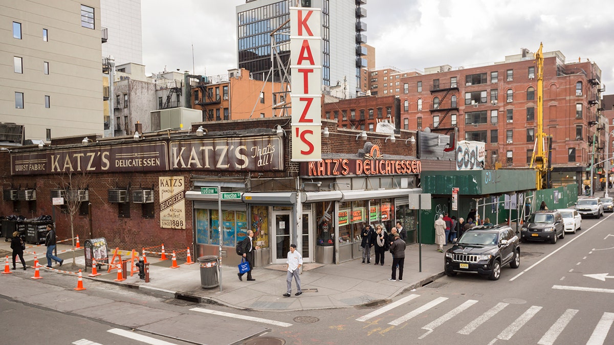 Exterior of Katz's Deli on Lower East Side of Manhattan, seen from above street level as passers by walk past