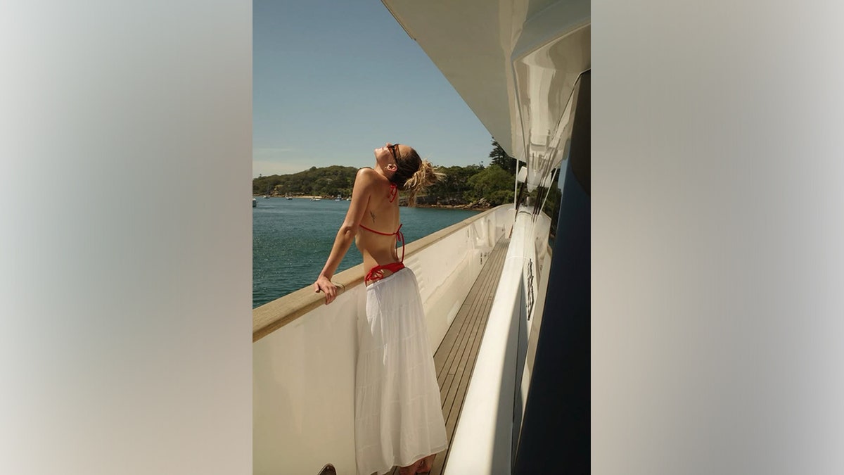 Kelsea Ballerini is seen aboard a boat during a trip to Australia in a bikini.