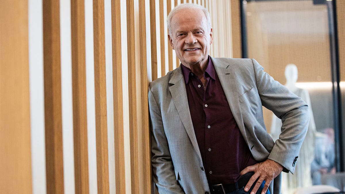 Kelsey Grammer smiling with hand on hip