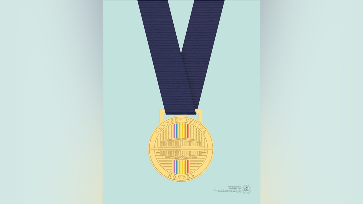 A gold Kennedy Center Honors medallion shown in full view, hanging from a bright blue ribbon against a neutral background.