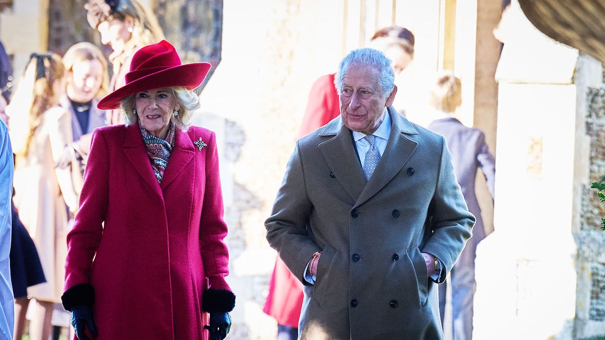 King Charles walking alongside Queen Camilla on Christmas Day.