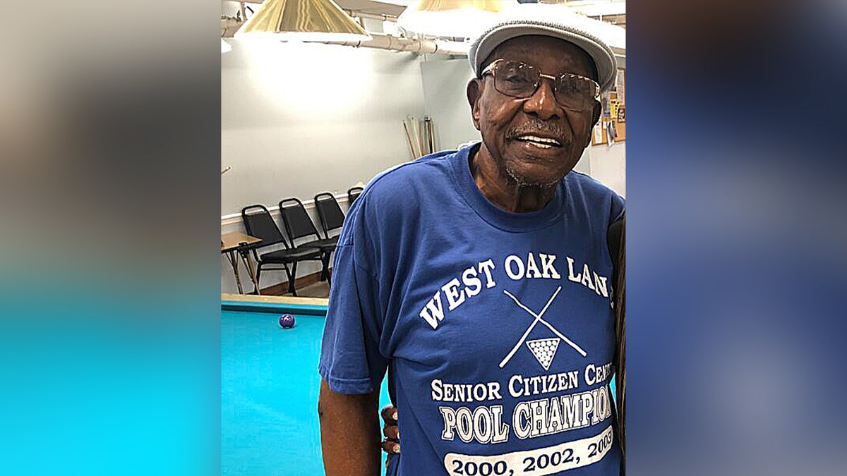man smiling in blue shirt