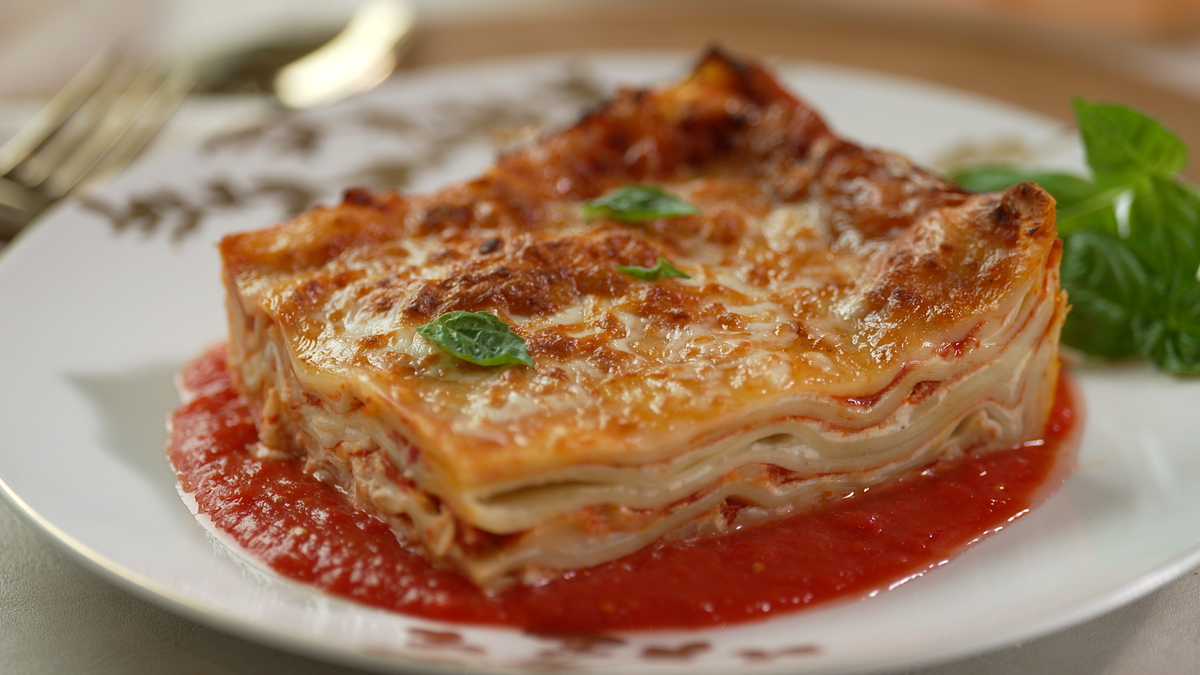 Lasagna is shown on a white plate.