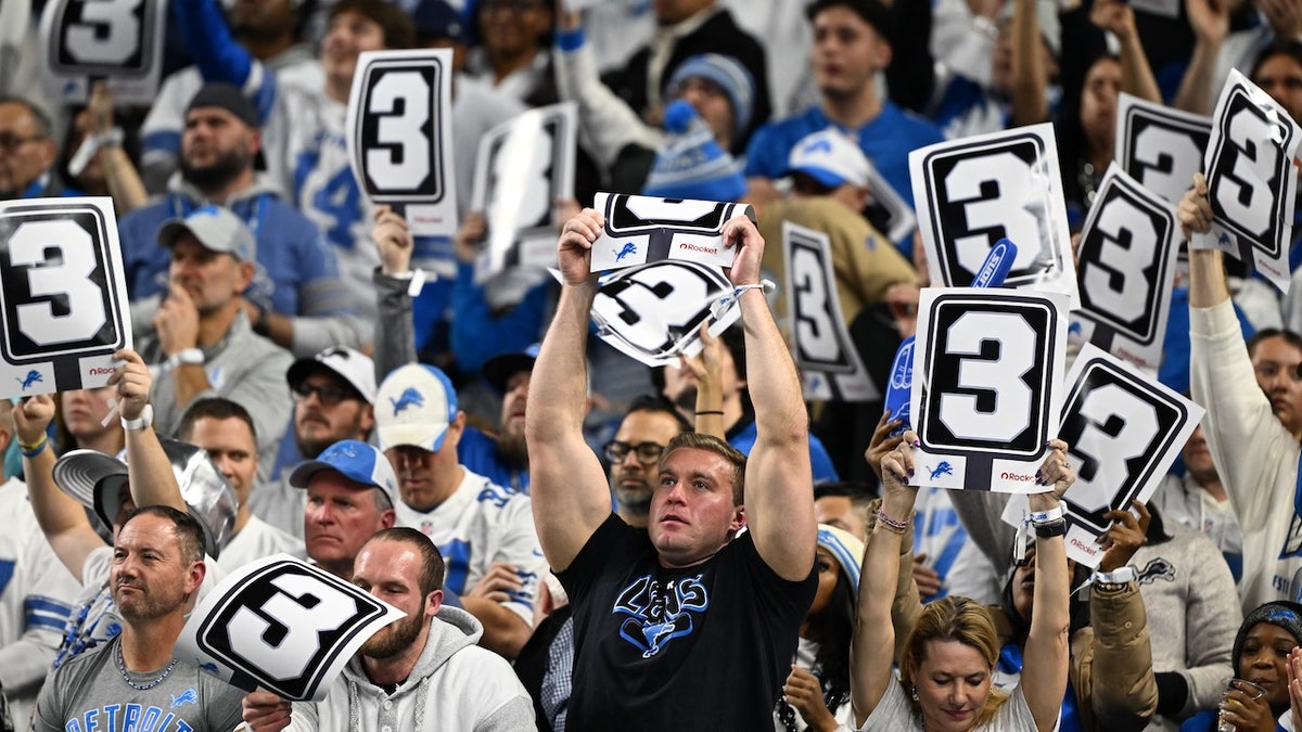 Detroit Lions fans hold up signs during the first half against the Dallas Cowboys at Ford Field.