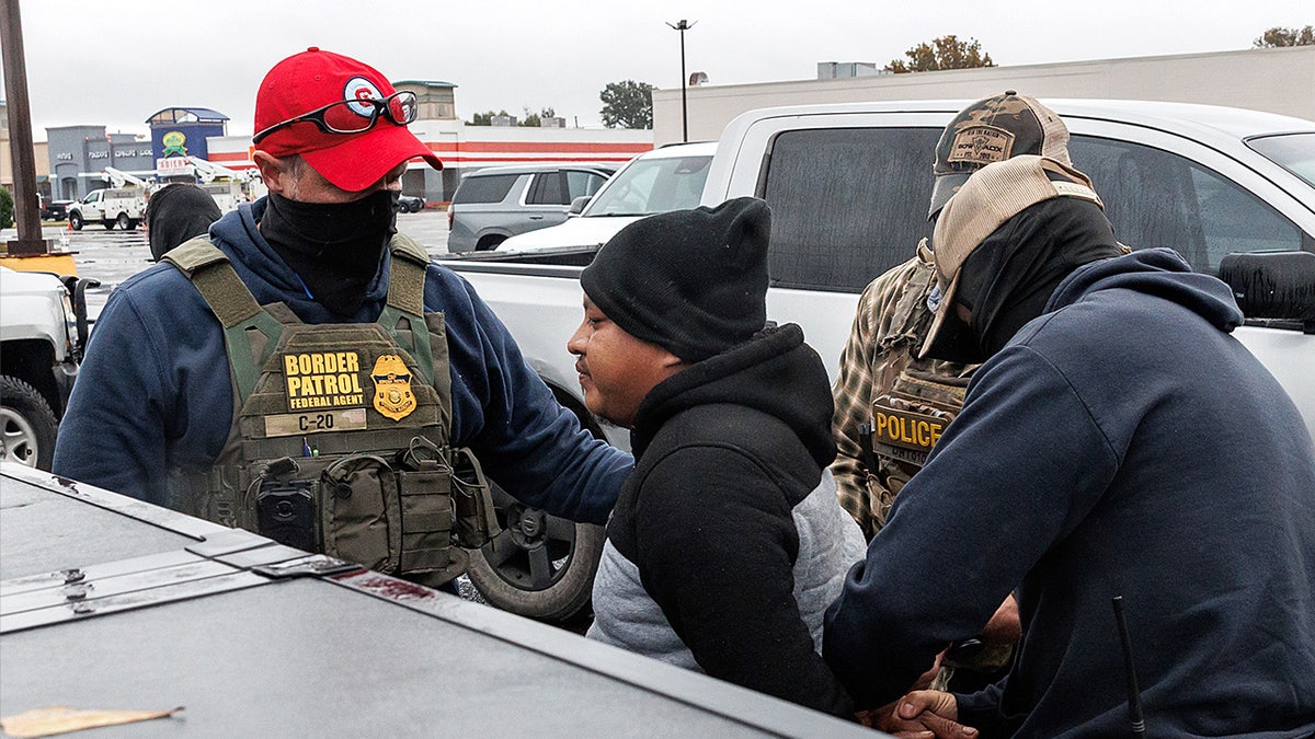 Customs and Border Protection agents detain a vehicle passenger after breaking the driver’s window during an enforcement stop in Kenner, Louisiana.