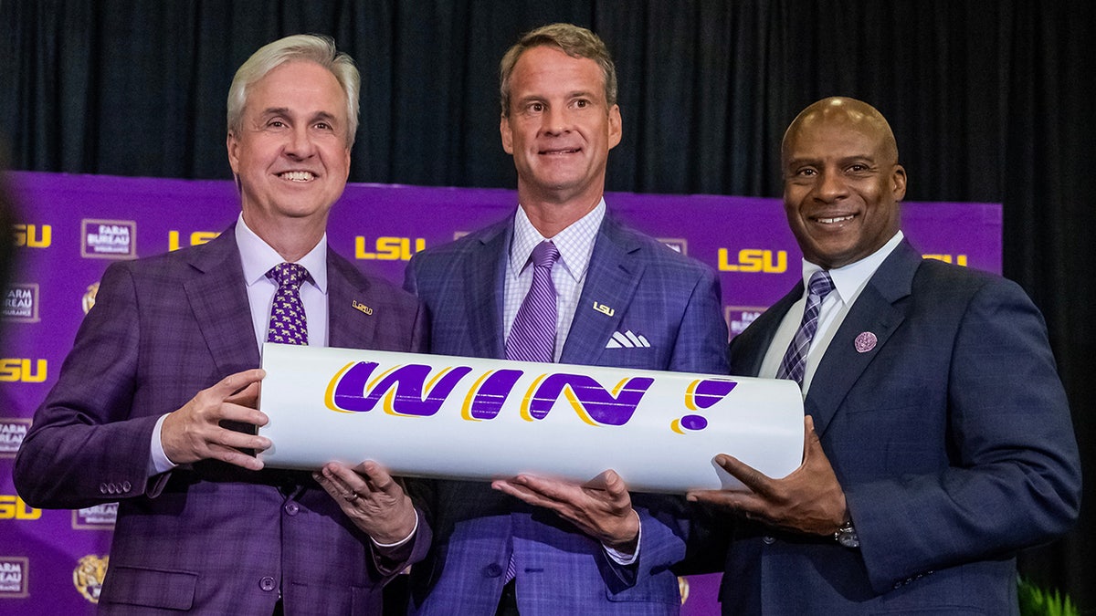 Lane Kiffin with LSU officials