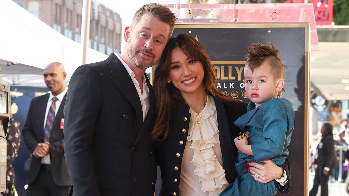 Macaulay Culkin, Brenda Song and their son on the Hollywood Walk of Fame in December 2023.