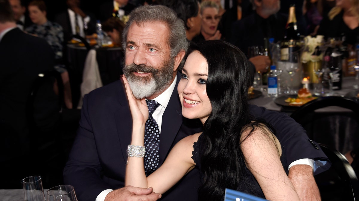 Mel Gibson and Rosalind Ross sit together at the Critics Choice Awards