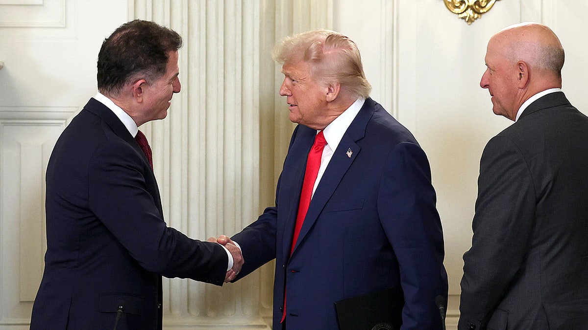 President Donald Trump greets Dell Technologies CEO Michael Dell as they arrive for the Invest America Roundtable at the White House.