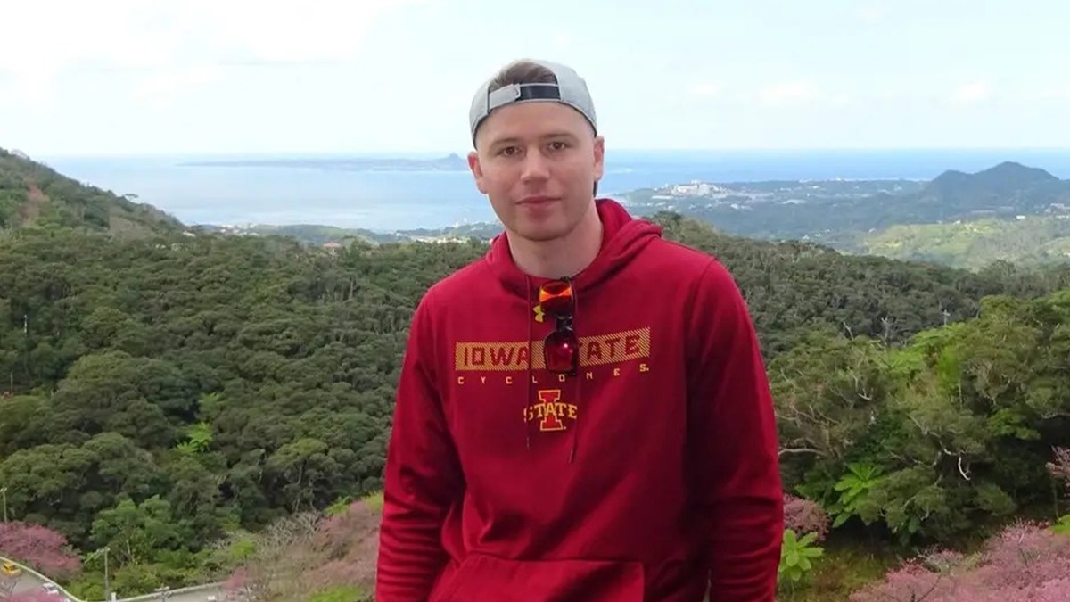man in red hoodie in coastal city