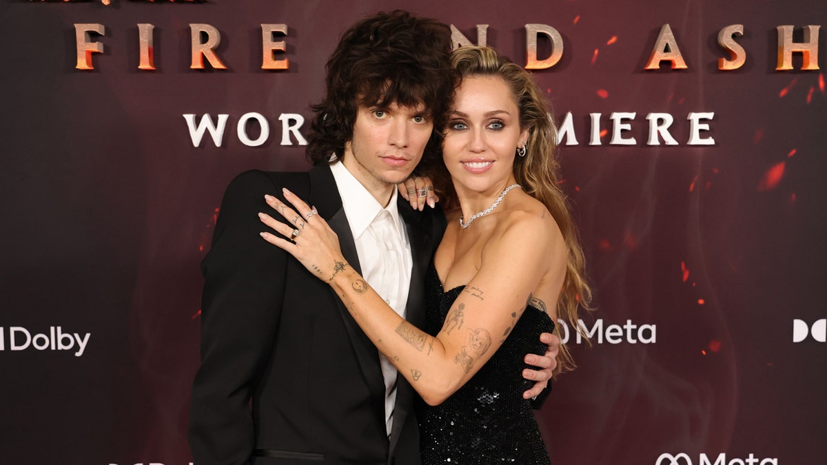 Maxx Morando and Miley Cyrus attend a movie premiere