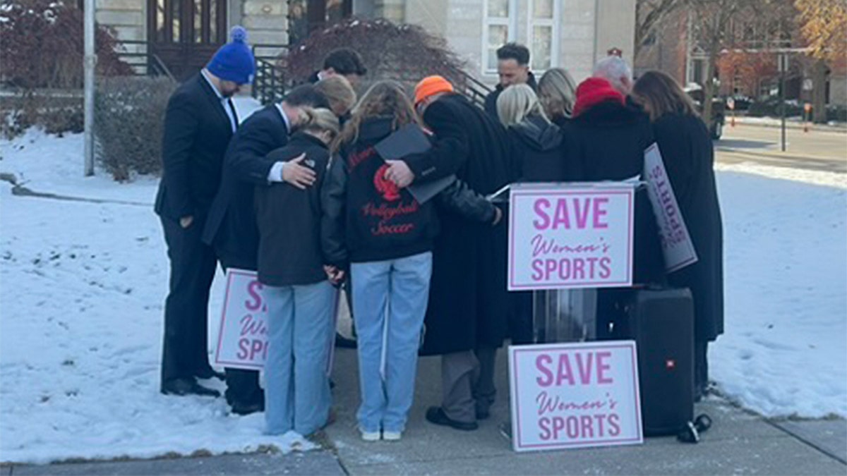 Sean and Briley Lechner join political candidate Laura Perry and other state representatives and advocates in prayer.