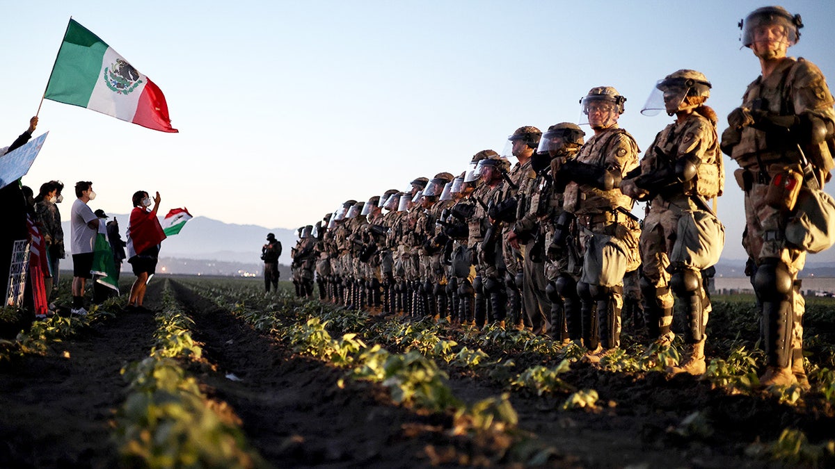 National Guard members stand in line to block protesters