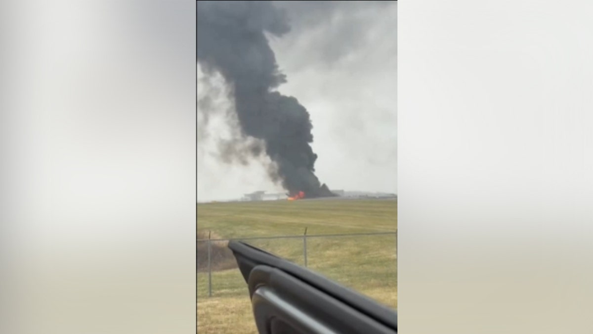 Fire seen at an airport after a plane crash