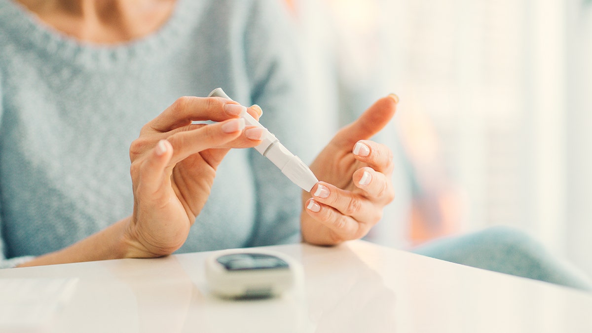 Diabetic woman checking blood