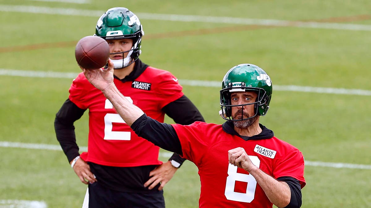 Aaron Rodgers throws a pass during a practice session