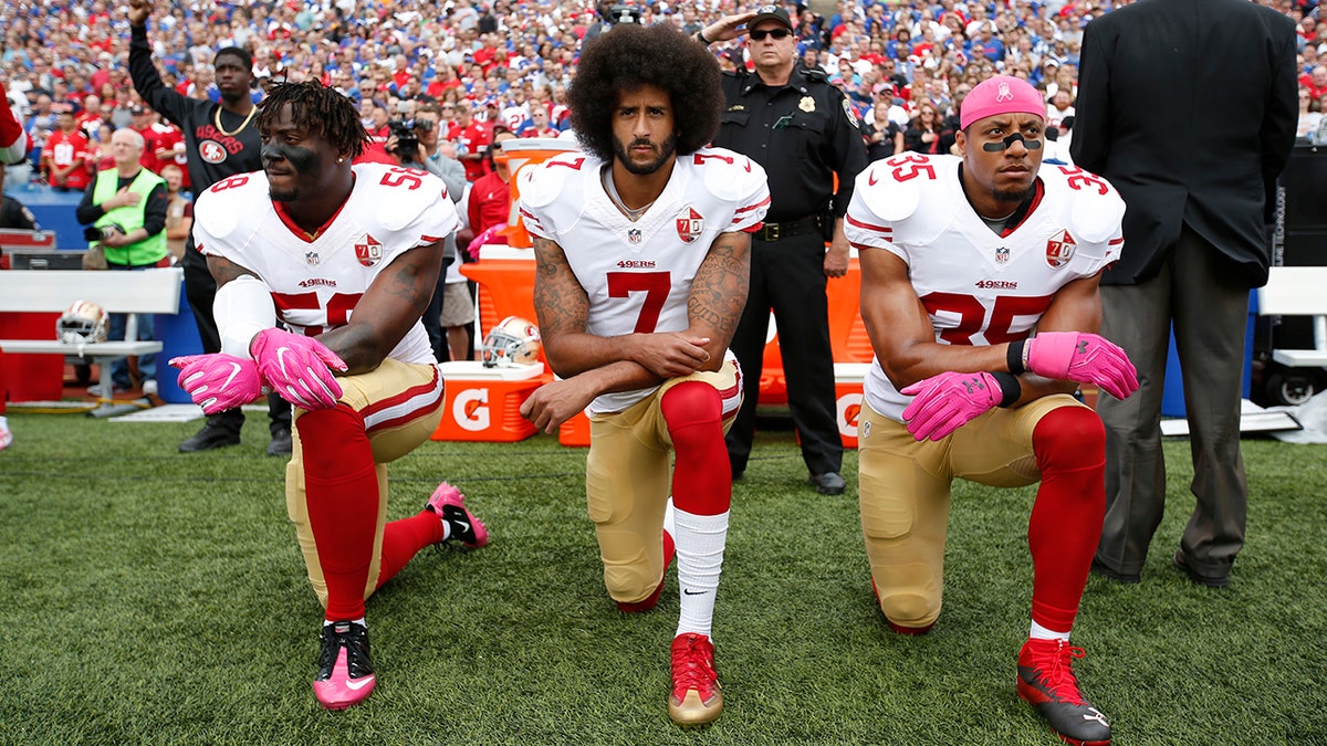 Colin Kaepernick kneels during the anthem
