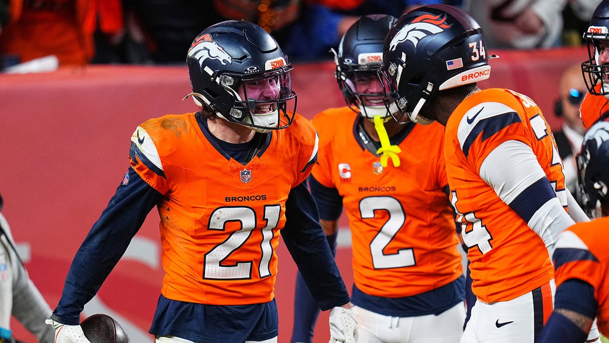 Riley Moss celebrates with his teammates