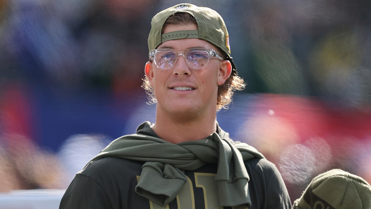 Jaxson Dart looks on from the sideline