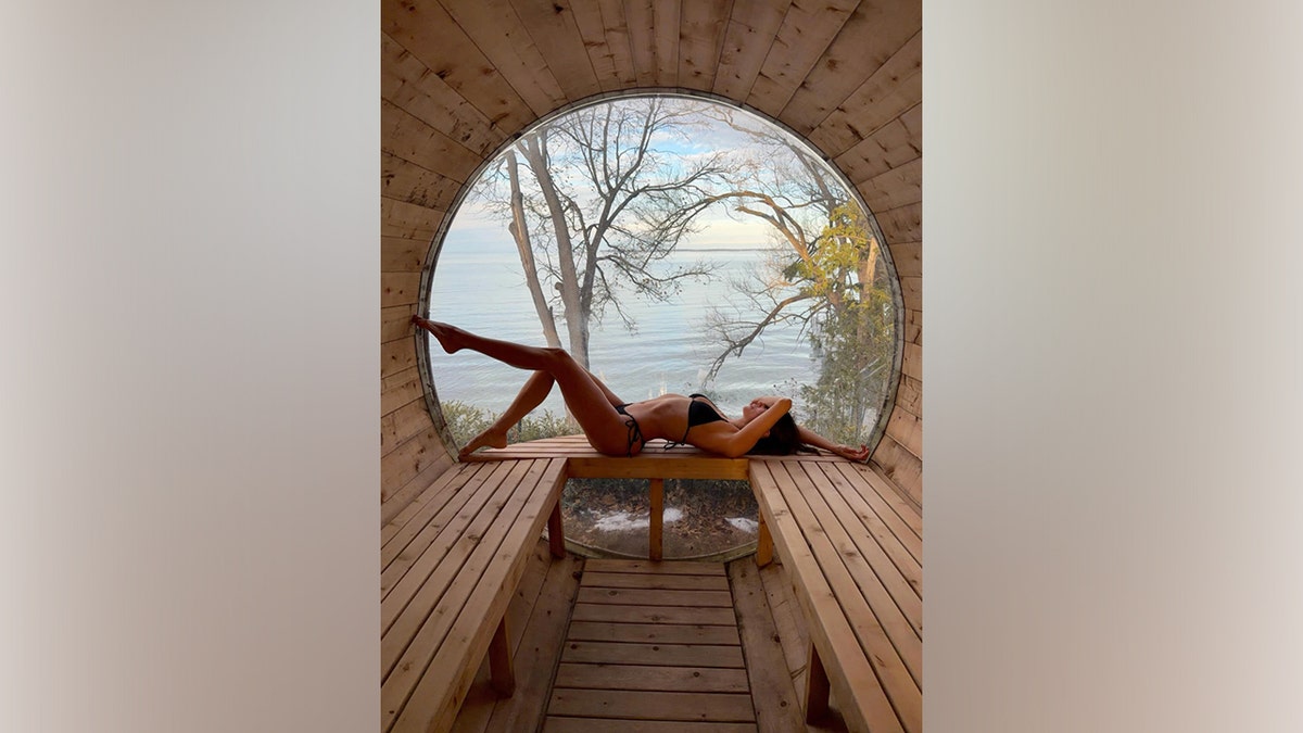 Nina Dobrev poses in a bikini while relaxing during a lakeside getaway.