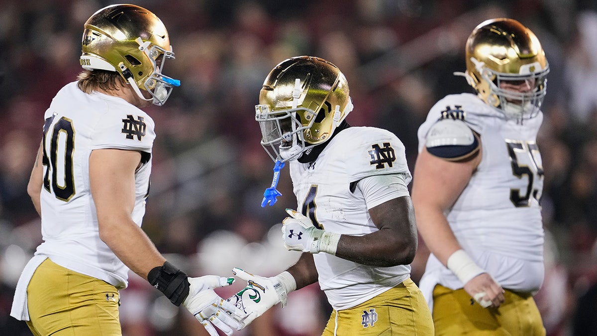 Jeremiyah Love shakes hands with teammates