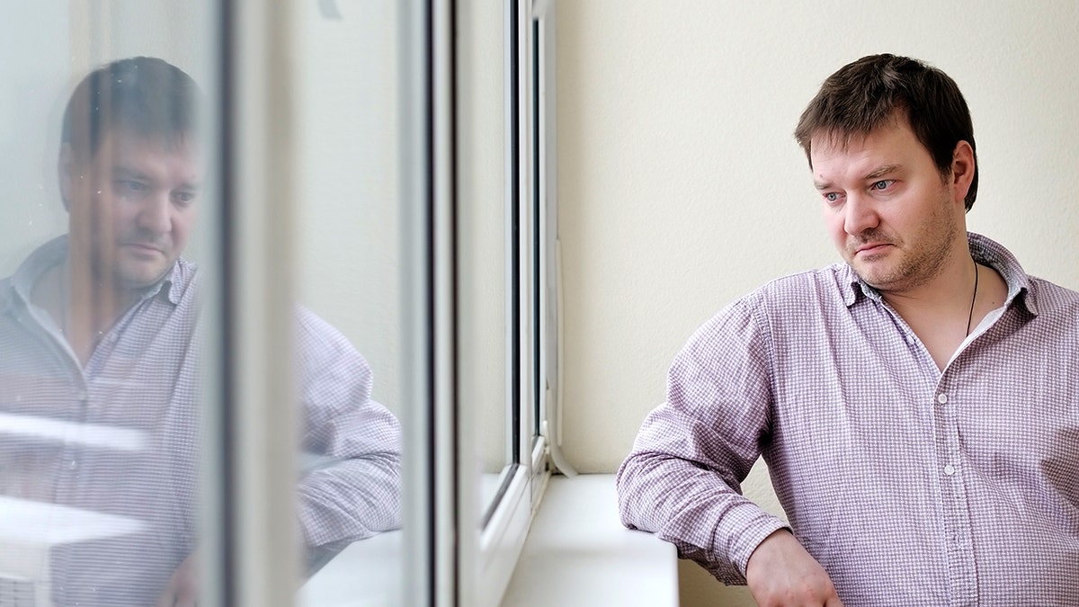 Middle age man looking out the window