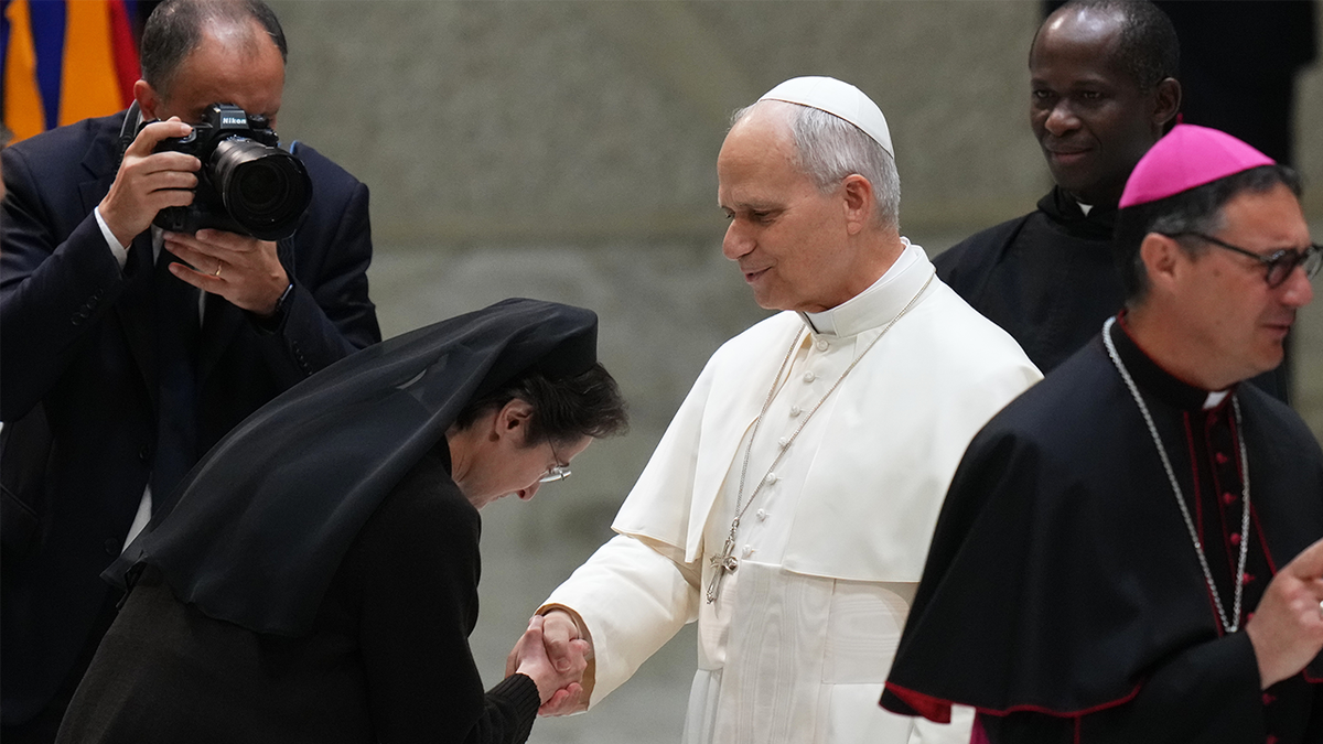 Pope Leo XIV shakes hands with Sister Raffaella Petrini