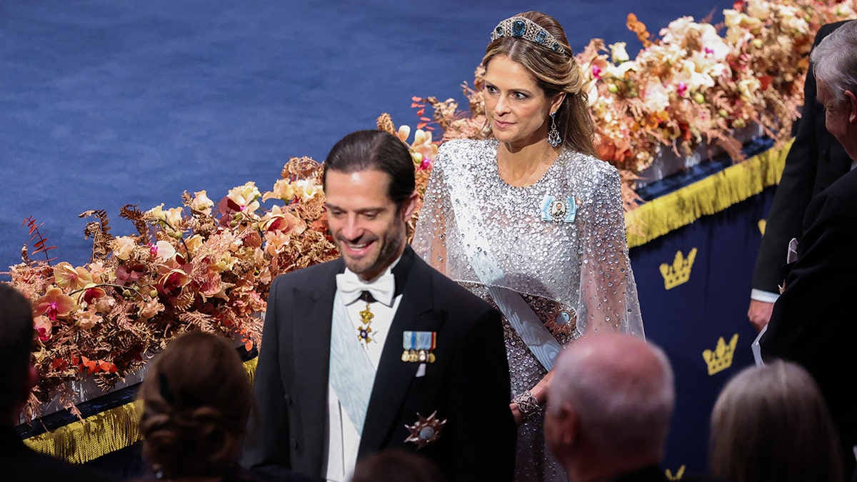 Prince Carl Philip walking ahead of his sister during a banquet.
