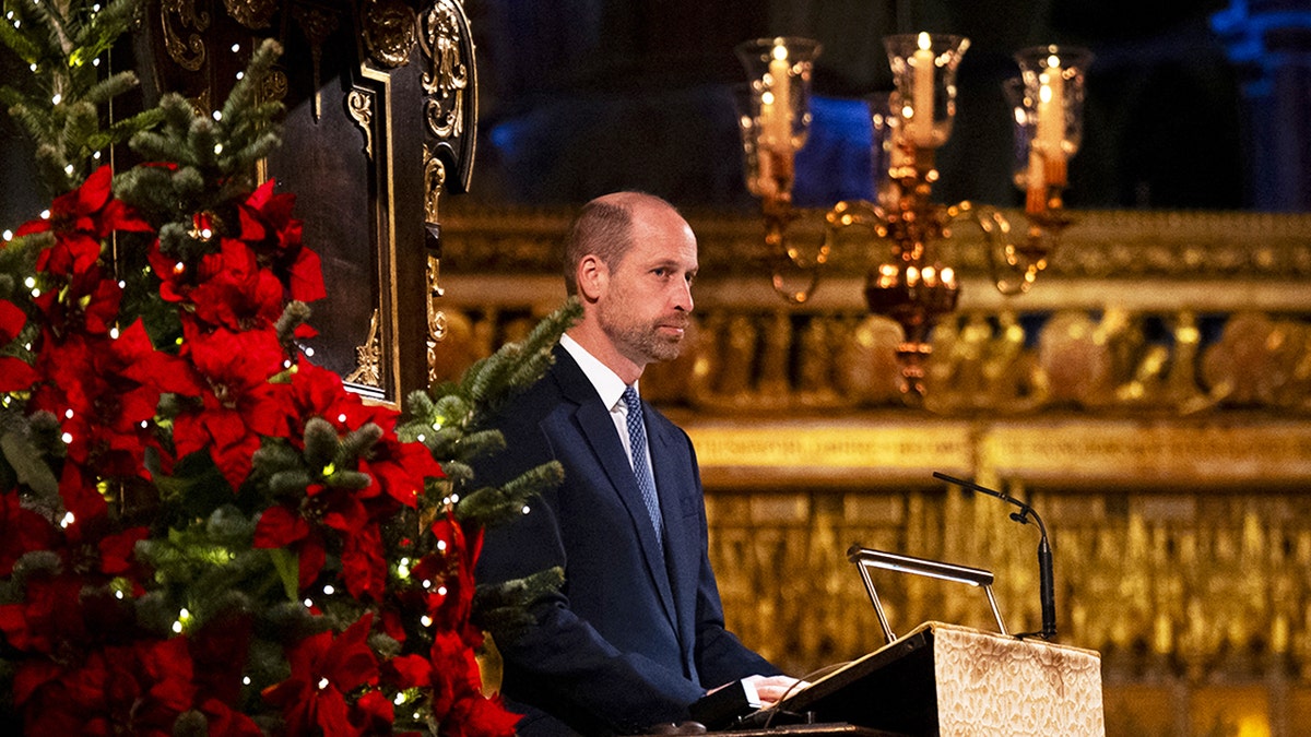 Prince William inside a church for Christmas service wearing a dark blue suit.