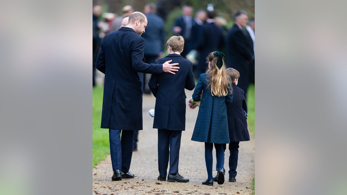 Prince William guiding his children during the Christmas Day walk.