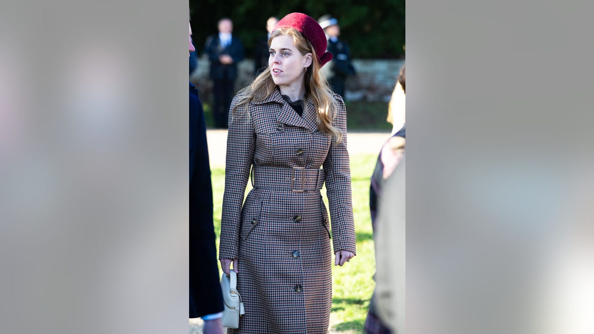 Princess Beatrice wearing a brown coat looking on at Christmas Day.