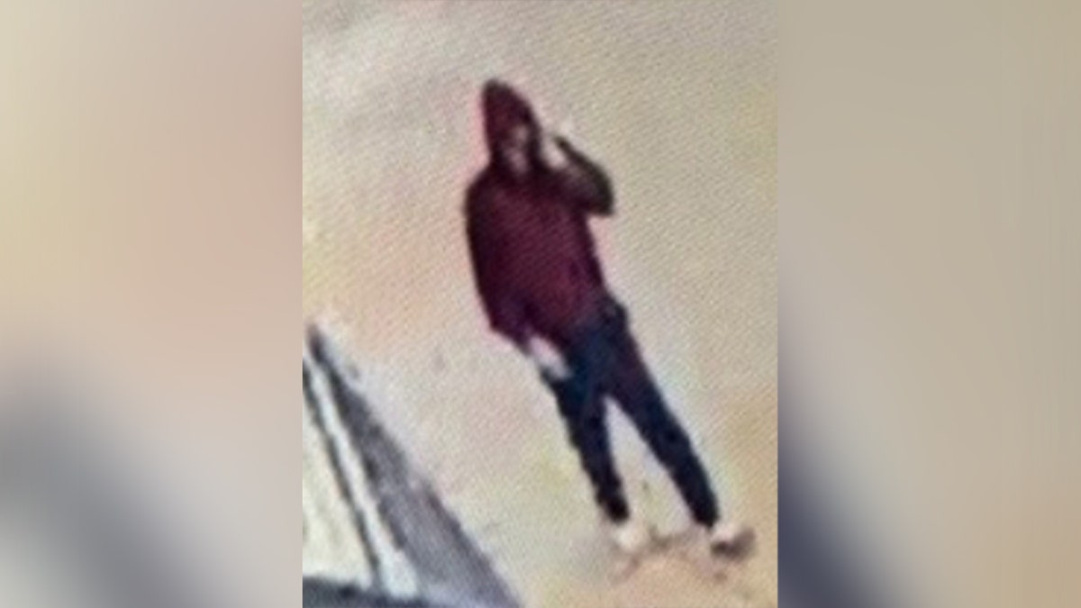 man in red hoodie and dark blue pants