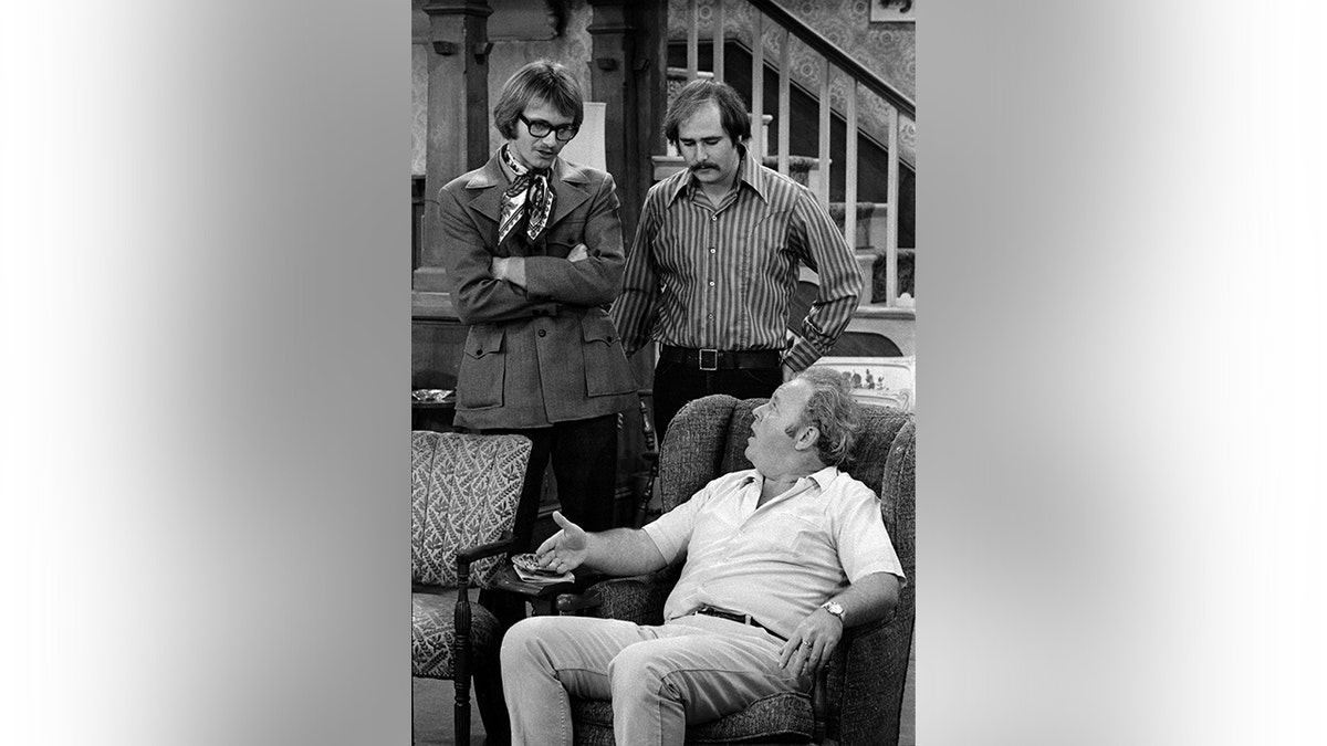 (from left) Anthony Geary as Roger, Rob Reiner as Michael Stivic and Carroll O'Connor (seated) as Archie Bunker