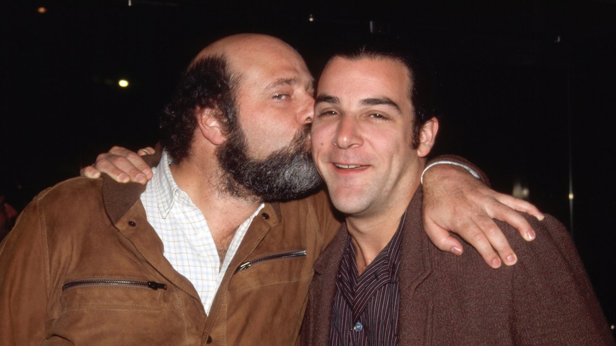 Rob Reiner kisses Mandy Patinkin on the cheek