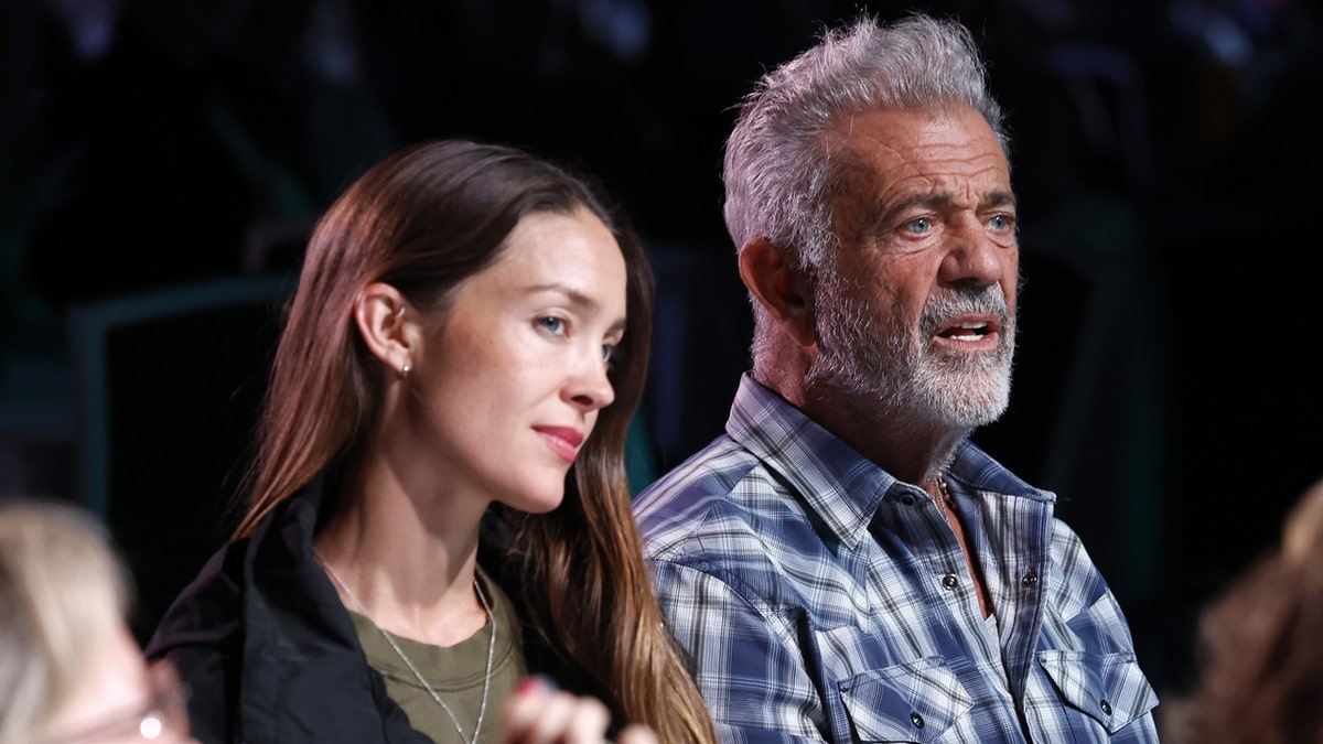 Rosalind Ross and Mel Gibson sit side-by-side