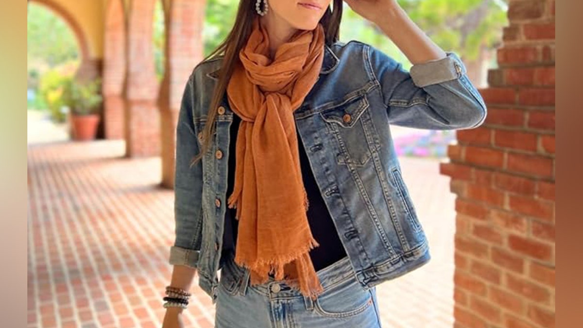 Woman wearing an orange scarf.